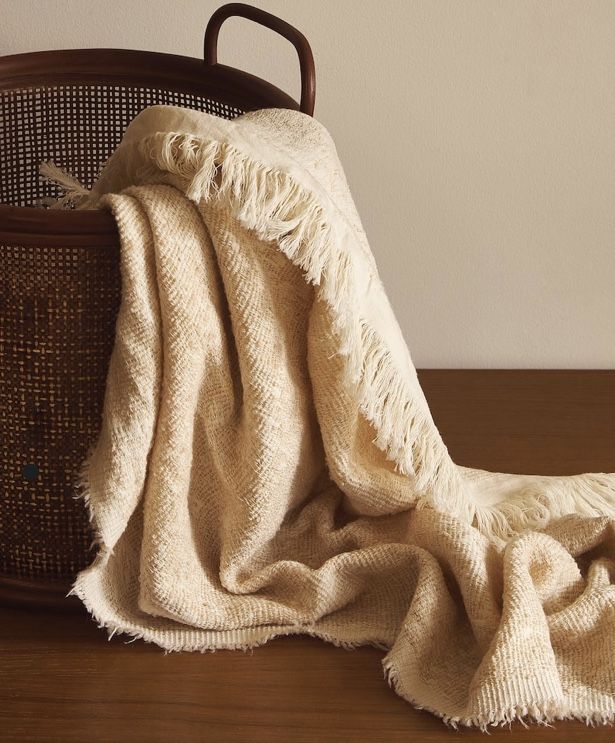 Soft blankets styled in a calm home interior